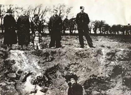 From Linda Waite - Bomb hole - 8.4.1943 - in field next to Well House. Linda's granny Moffat next to her mum and brother Norman